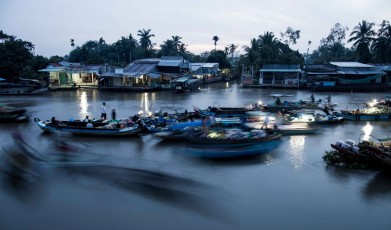 Colors of dawn on a floating market in motion