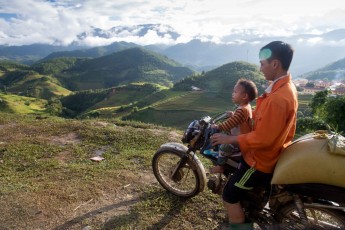 Dad and son riding the terraced rice
