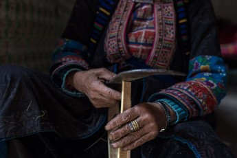 Dao woman cutting bamboo to make incense sticks