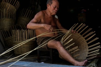 Old man making bamboo baskets
