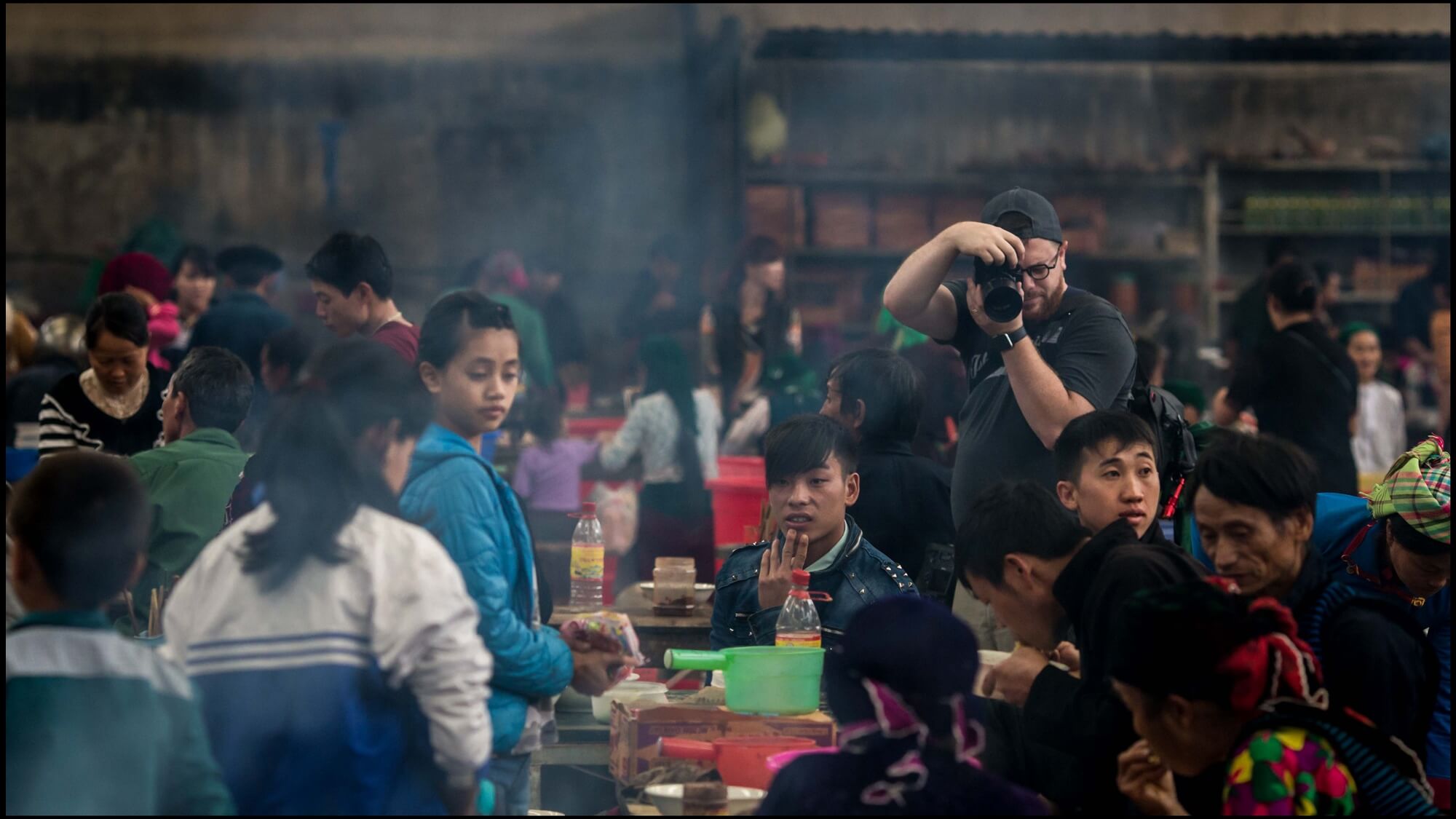 Photographer capturing busy restaurant activity in North Vietnam mountainous region