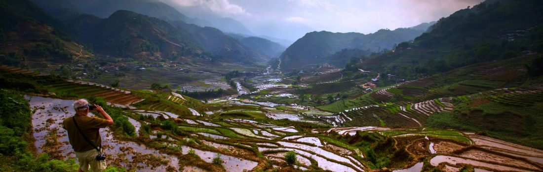 Photographer capturing rice terrace landscape panorama during plantation season